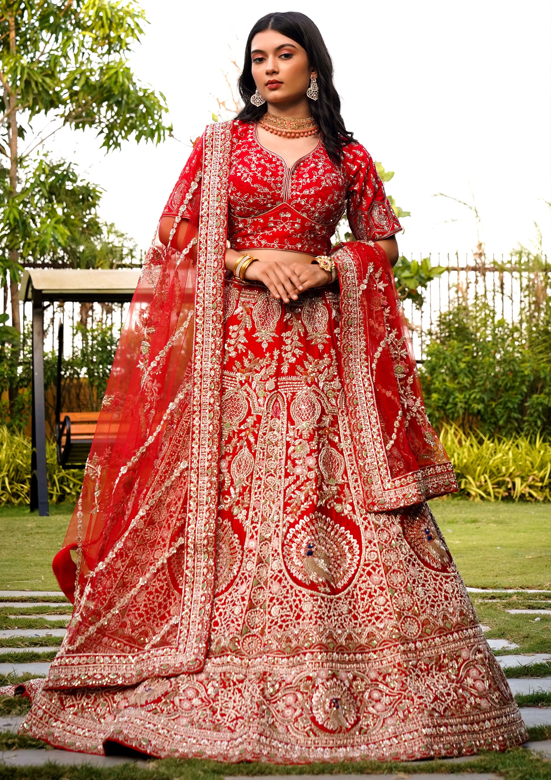 Elegant red wedding lehenga choli featuring detailed embellishments, ideal for a bride's special day