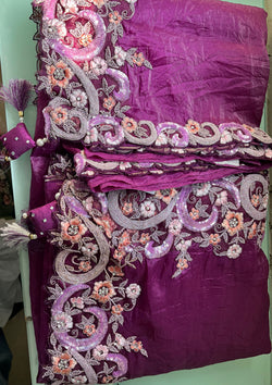  Elegant purple saree adorned with floral designs.