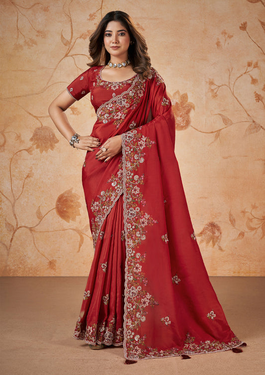 A vibrant red saree with intricate embroidery, showcasing traditional craftsmanship and elegance.