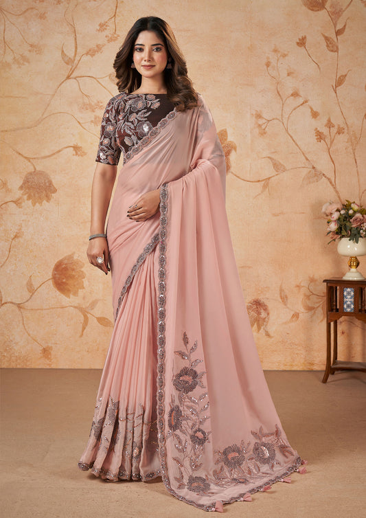 Pink georgette saree with intricate embroidery.