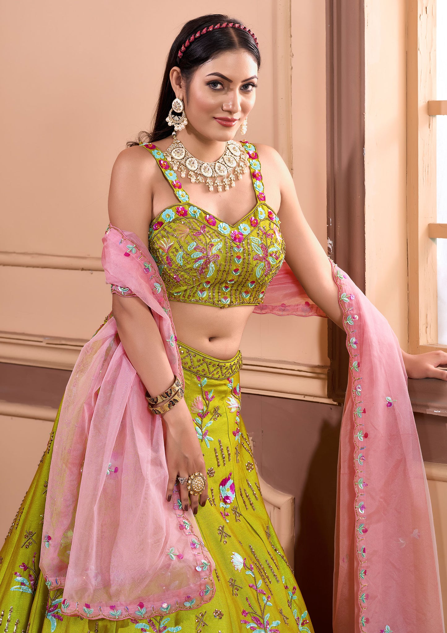 A stunning Indian woman wearing a green lehenga, showcasing the elegance of traditional attire.