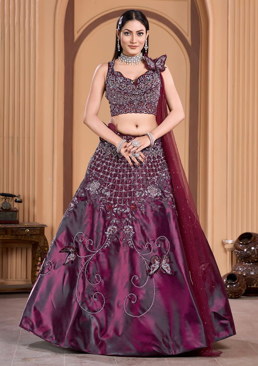 A stunning woman in a wine lehenga and matching blouse, adorned with elegant jewelry.