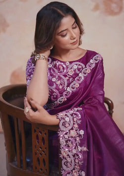  Elegant purple saree adorned with floral designs.